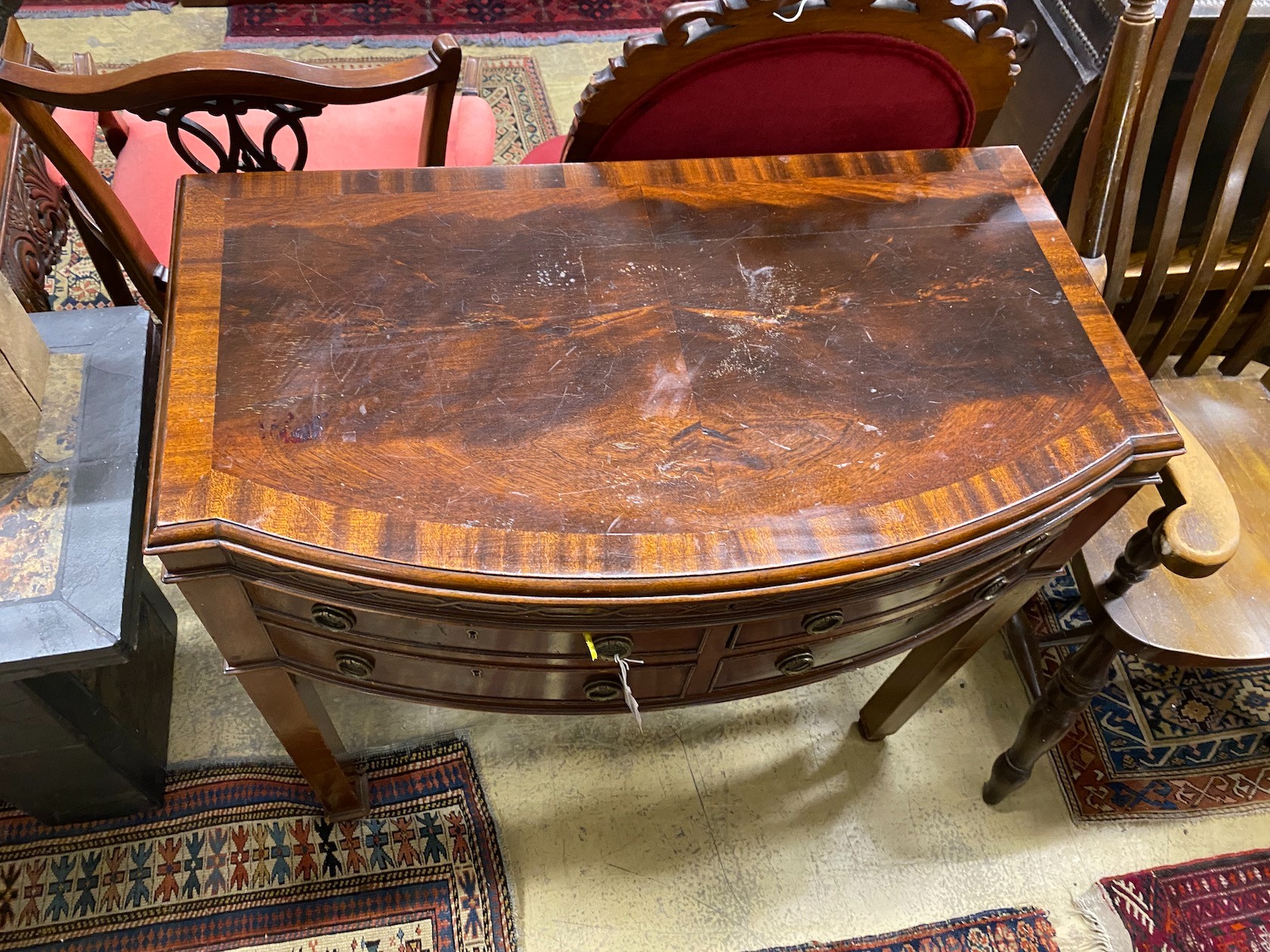 An early 20th century matched silver plated part canteen, in mahogany bow front four drawer table case, width 88cm, depth 49cm, height 85cm